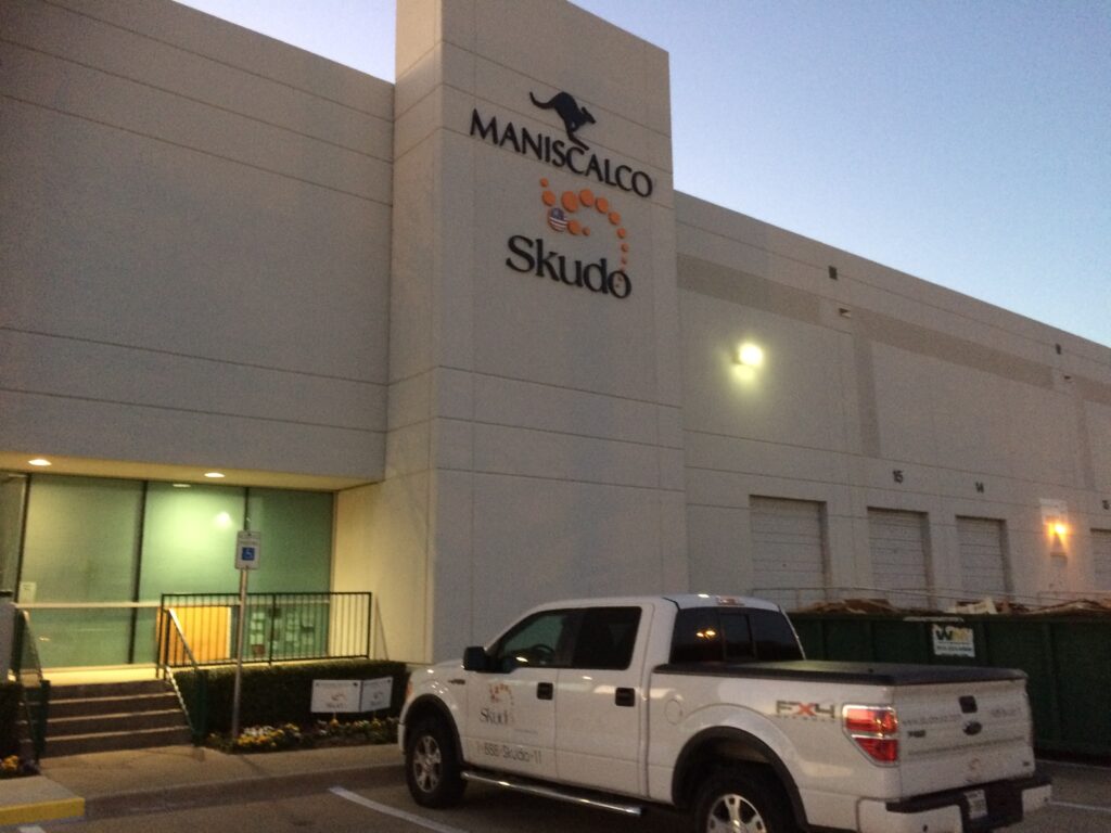 a truck parked in front of an industrial building