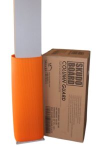 Orange column guard partially covers a white column, standing beside a brown cardboard box labeled "Skudo Board Column Guard."